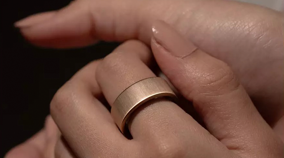 Woman's manicured hand wearing an Ultrahuman AIR ring